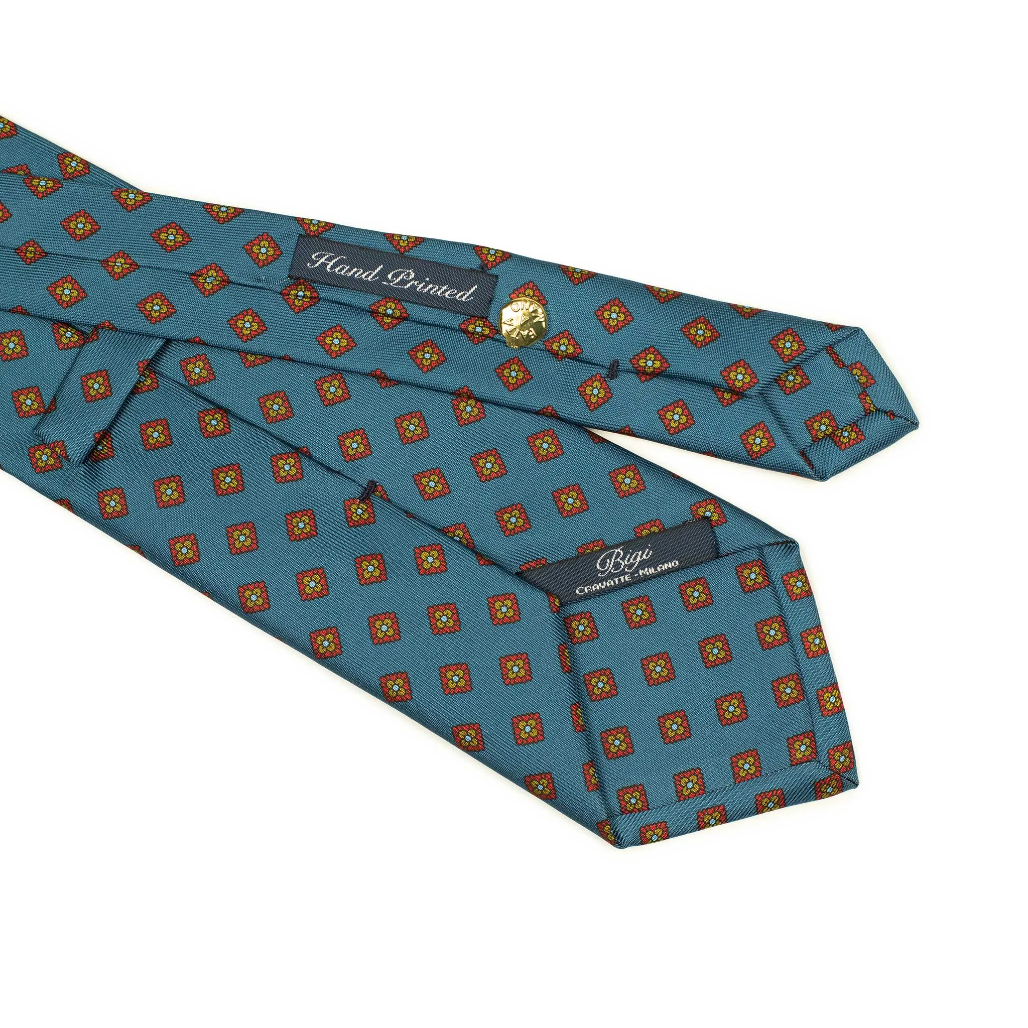 Hand-printed slate blue silk twill tie, rust and olive medallion print