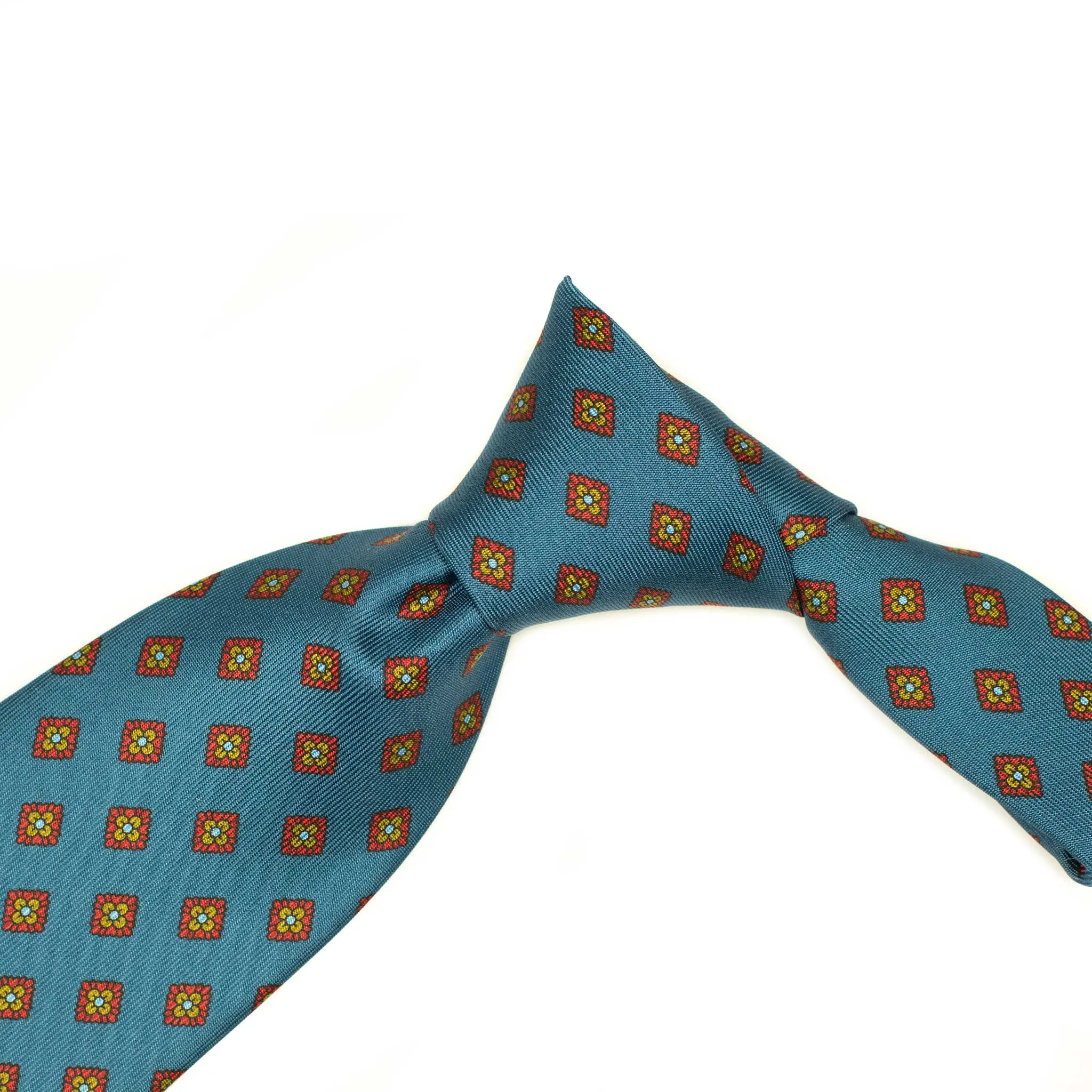Hand-printed slate blue silk twill tie, rust and olive medallion print